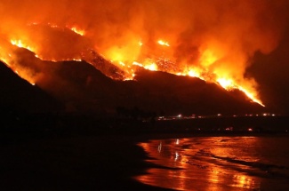 Flames from the Thomas Fire reflect in the waves just west of Ventura. Its proximity to the ocean provided researchers a unique opportunity.