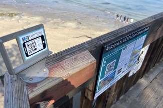 The CoastSnap cradle on the steps to East Campus Beach